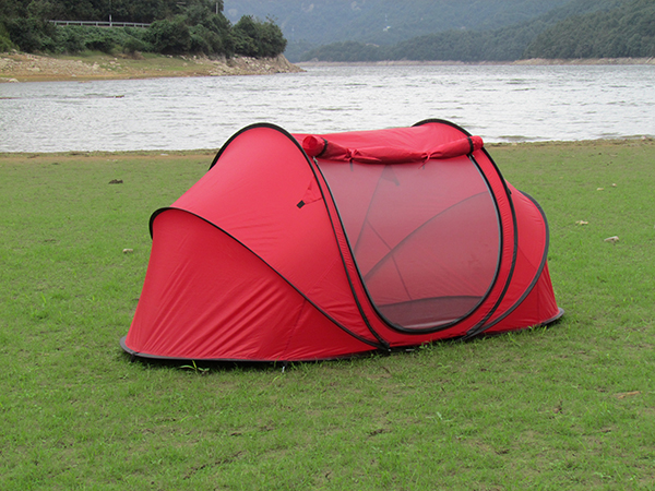 Red instant pop‑up tent lakeside